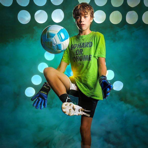 High School Soccer Player Kicking a Soccer Ball