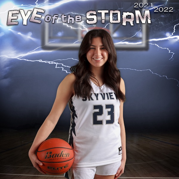 High school basketball player posing with her basketball