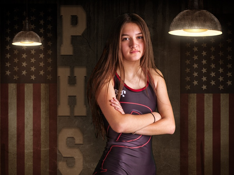 Young woman posing in wrestling uniform